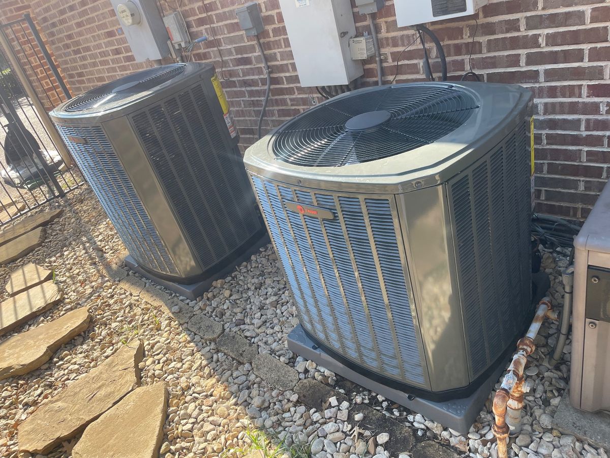 Trophy Club HVAC — pair of new outdoor AC condensers on pads